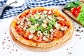 Close up view on pizza on white wooden background with ingridients. Italian cuisine. Royalty Free Stock Photo