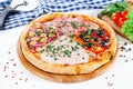 Close up view on pizza on white wooden background with ingridients. Italian cuisine. Royalty Free Stock Photo