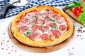 Close up view on pizza on white wooden background with ingridients. Italian cuisine. Royalty Free Stock Photo