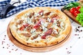 Close up view on pizza on white wooden background with ingridients. Italian cuisine. Royalty Free Stock Photo