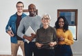 Ready to get down to business. Portrait of a group of confident businesspeople seated together inside of the office Royalty Free Stock Photo