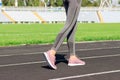 Ready to go. Close up photo of shoe of female athlete on the starting line. Girl on Stadium track, preparing for a run. Sports and Royalty Free Stock Photo