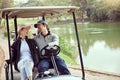 Ready to hit the course. a smiling young couple riding in a cart on a golf course. Royalty Free Stock Photo