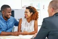 Ready to invest in their future. a young couple consulting a financial advisor. Royalty Free Stock Photo