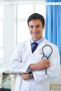 Ready to make a diagnosis. Portrait of a handsome young doctor holding a patient chart and a stethoscope. Royalty Free Stock Photo