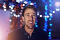 Ready to party. Portrait of a happy young man posing alone on the balcony of a nightclub. Royalty Free Stock Photo