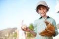 Ready to play ball. Cropped portrait of a young boy playing baseball in the yard with his father in the background. Royalty Free Stock Photo