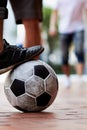 Ready to score. Cropped image of a mans foot on a soccer ball in the street. Royalty Free Stock Photo