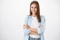 Ready to show who boss. Portrait of confident good-looking daring woman in blue blouse over t-shirt crossing hands over Royalty Free Stock Photo