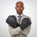 Ready to take on all business competition. Studio shot of an african american businessman wearing boxing gloves. Royalty Free Stock Photo