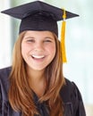 Ready to take the next step in her life. Head and shoulders portrait of a pretty college student in her graduation gown. Royalty Free Stock Photo