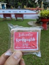 Ready to use piece of traditional thanaka paste. Sold in a buddhist pagoda. Thanaka used as natural cosmetic for the skin.