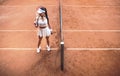 Ready to win! Top view of sexy woman tennis player looking away on clay tennis court. Full length shot of sporty girl on tennis Royalty Free Stock Photo