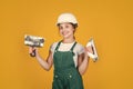 Ready to work. happy girl use spatula tool. teen builder wear safety helmet. young worker in protective hard hat Royalty Free Stock Photo