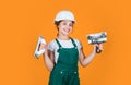 Ready to work. happy girl use spatula tool. teen builder wear safety helmet. young worker in protective hard hat Royalty Free Stock Photo