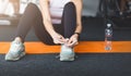 Ready for training. Woman tying laces preparing for workout