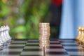 Ready two pieces of chess pieces on a chess board and a stack of euro coins in the middle