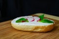 Vegetable sandwich on wooden board with dark background