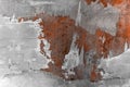 Real abstract pattern of peeling worn red wall with layers of paints and cement