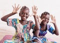 Real African Girls Enjoying Hands Up Throwing Confetti from their hands in a White Room