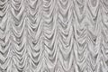 Real background of the veil on stage in the concert hall. Texture of the curtains in a music hall. Curtain of silver fabric