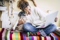 Real best friends cheerful woman working at laptop on the terrace at home while hug her best love and friends smiling dog pug Royalty Free Stock Photo