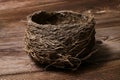 Real bird nest empty isolated on wooden background. Royalty Free Stock Photo