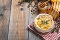 A real Camembert from France with thyme, honey and toasted bread on old wooden rustic table. Soft cheese on a wooden background wi Royalty Free Stock Photo