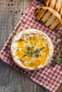 A real Camembert from France with thyme, honey and toasted bread on old wooden rustic table. Soft cheese on a wooden background. T Royalty Free Stock Photo