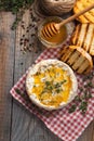 A real Camembert from France with thyme, honey and toasted bread on old wooden rustic table. Soft cheese on a wooden background. T Royalty Free Stock Photo