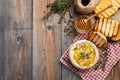 A real Camembert from France with thyme, honey and toasted bread on old wooden rustic table. Soft cheese on a wooden background wi