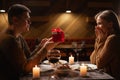Real candlelight dinner for two, valentine& x27;s day date, couple having dinner man giving a woman a gift, romantic Royalty Free Stock Photo