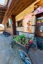 A real cart with flowers at the entrance to a rural restaurant in the Balkan village of Zheravna, Bulgaria Royalty Free Stock Photo