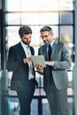 Real collaborations in real time. two colleagues using a digital tablet together in a modern office.