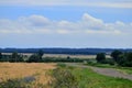 Real countryside paved road along the wheat field