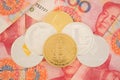 Real cryptocurrency coins on chinese yuan bills