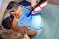 real. dentist treats patient with caries, drills tooth and installs filling