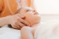 Real doctor osteopath hands does physiological and emotional therapy for eight year old kid girl. pediatric osteopathy treatment s