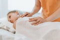 Real doctor osteopath hands does physiological and emotional therapy for eight year old kid girl. pediatric osteopathy treatment s