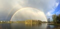 Real double rainbow over the lake. Spring landscape.