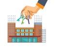 Real estate agency. Hand with keys on background construction houses. Royalty Free Stock Photo