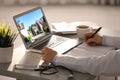 Real estate agency online service. Doctor choosing new house via laptop Royalty Free Stock Photo