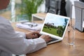 Real estate agency online service. Doctor choosing new house via laptop, closeup Royalty Free Stock Photo