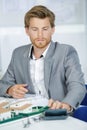 Real estate agent above house model on table Royalty Free Stock Photo