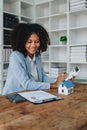 Real estate agent, African American businesswoman Africans use smartphone and calculators to offer mortgages to their Royalty Free Stock Photo