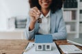Real estate agent, African American businesswoman Africans use smartphone and calculators to offer mortgages to their Royalty Free Stock Photo