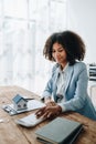 Real estate agent, African American businesswoman Africans use smartphone and calculators to offer mortgages to their Royalty Free Stock Photo