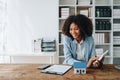 Real estate agent, African American businesswoman Africans use smartphone and calculators to offer mortgages to their Royalty Free Stock Photo