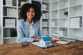 Real estate agent, African American businesswoman Africans use smartphone and calculators to offer mortgages to their Royalty Free Stock Photo