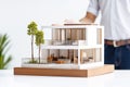 Real estate agent or architect presenting a house model. Generative Ai